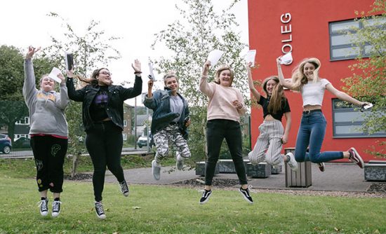 students celebrating outside campus