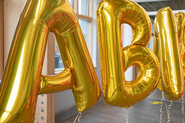 Gold A B balloons