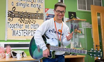 Independent Living Skills student with guitar