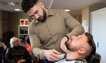 Barbering student shaving neck