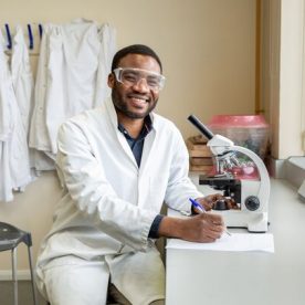 Science student using microscope