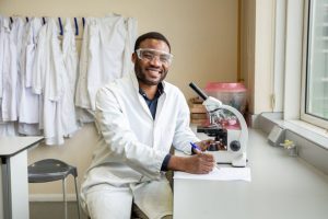 Science student using microscope