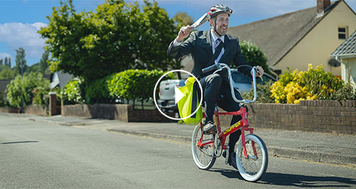 Man riding Raleigh Chopper bike delivering newspapers