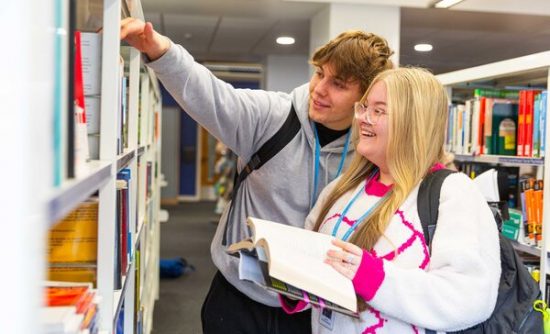 Higher Education students in a library