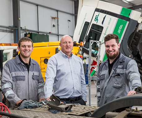 Employer with apprentices in workshop